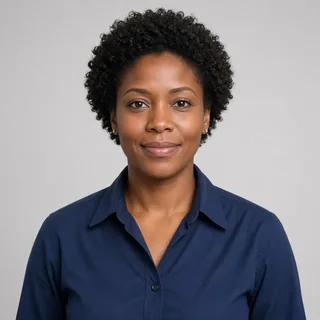 AI-generated portrait of the Electrician Mentor, a fictional person: a woman with short coily hair in a navy work shirt