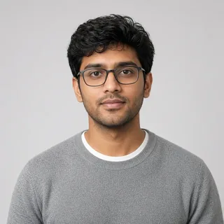 AI-generated portrait of the Software Developer Mentor, a fictional person: a young man with wavy black hair and rectangular glasses in a grey sweater